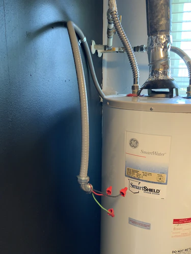 Forty gallon GE SmartWater tank in a Casselberry closet with the new 240 volt whip capped off alongside it