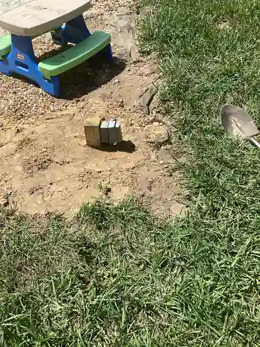 New post mounted outdoor outlet set in the backfilled trench beside a childrens picnic table in a Mount Dora backyard