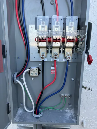 ABB fusible service disconnect with three phase feeders and a bonded ground bar at the EMS warehouse