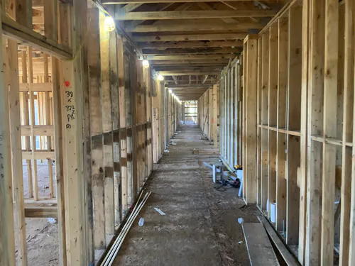 Temporary lighting strung down a framed corridor at Hawthorne Heights