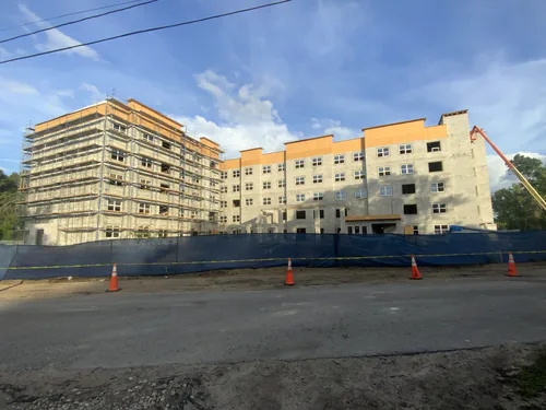 Hawthorne Heights apartment building from the street with scaffolding and a lift on the far end