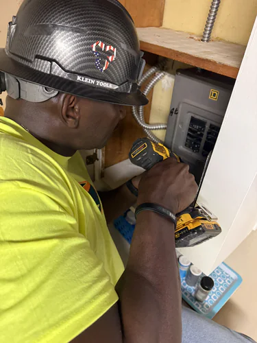 Spectrum Electric technician adding a breaker to a Square D load center in a Winter Park home