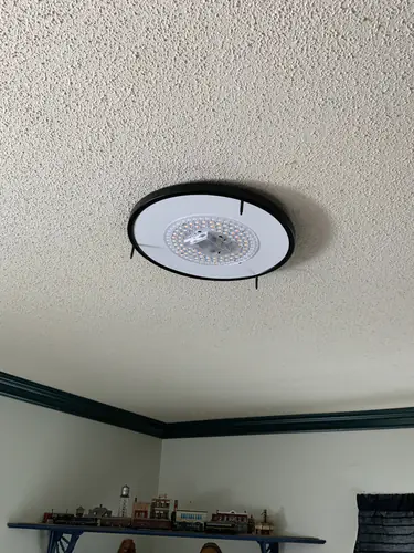 LED flush mount mounted on a textured bedroom ceiling in Casselberry with the diffuser off and the LED ring exposed