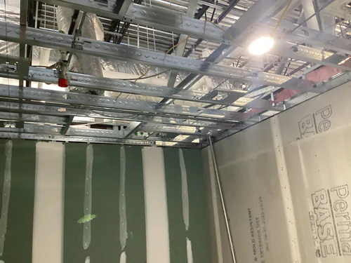 Suspended ceiling grid, ductwork and conduit above the Massey Cadillac build out