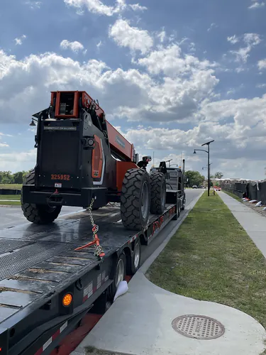 JLG telehandler delivered on a lowboy trailer at the Lady Lake Market site