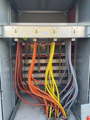 Switchboard bus bars labeled A, B, C and N with feeders landed at Lady Lake Market
