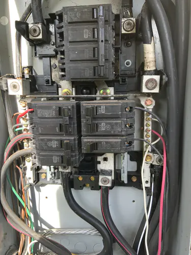 Outdoor service equipment with a 200 amp GE main breaker above 100 amp, 35 amp and 30 amp two pole breakers
