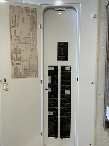GE PowerMark Gold load center in Winter Park with a handwritten circuit directory and tandem breakers filling the bottom rows